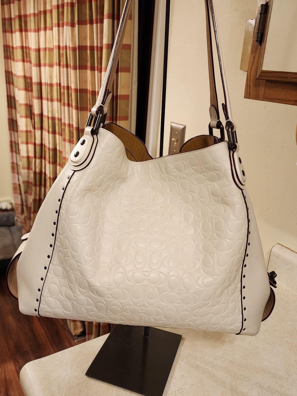 Coach Edie Shoulder Bag 31 with rivets in a signature embossed leather. 